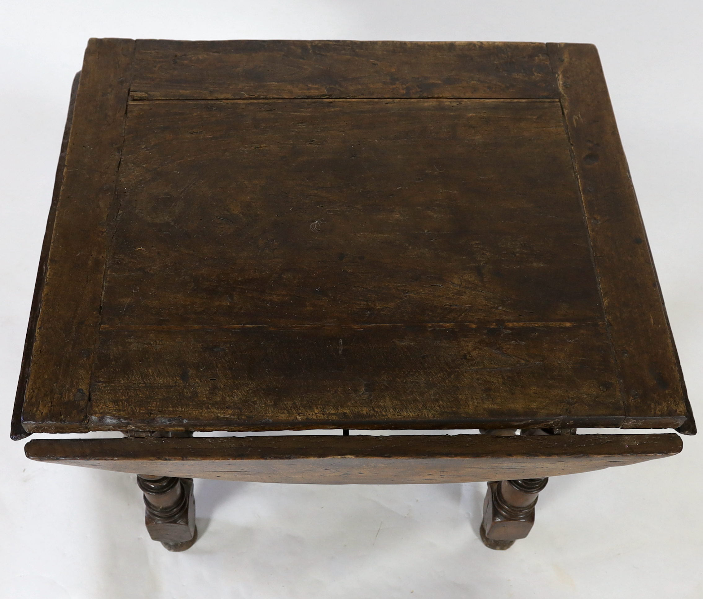 A late 17th century Spanish walnut dining table, 100 x 83cm with flaps down